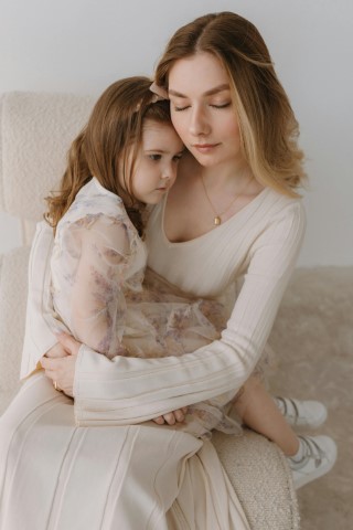 two-people-embracing-with-in-white-clothes-with-neutral-background